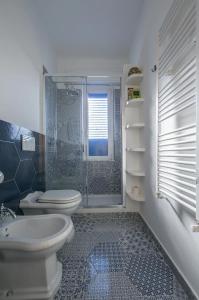 a bathroom with a toilet and a glass shower at CasaViva - Blue Penthouse with parking in Santa M in Santa Margherita Ligure