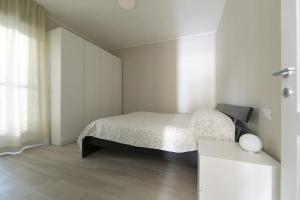 a white bedroom with a bed and a desk at CasaViva - Blue Penthouse with parking in Santa M in Santa Margherita Ligure