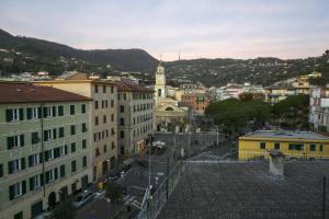 a view of a city with buildings and a clock tower at CasaViva - Blue Penthouse with parking in Santa M in Santa Margherita Ligure