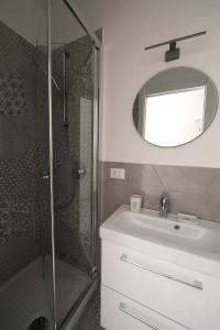 a bathroom with a shower and a sink and a mirror at CasaViva - Blue Penthouse with parking in Santa M in Santa Margherita Ligure