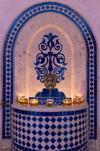 a room with a fireplace with a bear in it at Riad Arbre Bleu in Marrakech