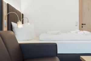 a bed sitting on top of a table with a chair at Appartement Mühlkogel in Bad Goisern