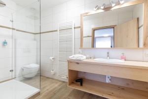 a bathroom with a sink and a toilet and a mirror at Appartement Mühlkogel in Bad Goisern +15 photos