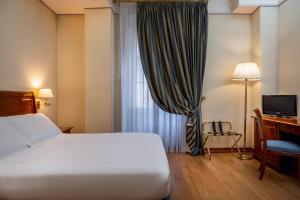 Postel nebo postele na pokoji v ubytování Hotel Oceania