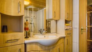 a bathroom with a sink and a mirror at Ferienwohnungen Altes Rathaus in Vogtsburg +71 photos