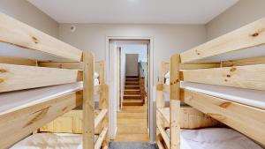 a room with four bunk beds with a staircase at Nouveau ! Chalet pied des pistes in Champagny-en-Vanoise