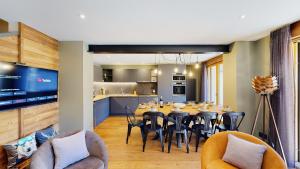 a dining room and kitchen with a table and chairs at Nouveau ! Chalet pied des pistes in Champagny-en-Vanoise