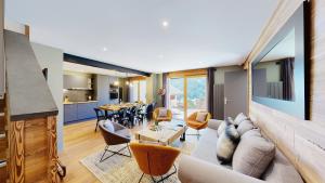 a living room with a couch and a table at Nouveau ! Chalet pied des pistes in Champagny-en-Vanoise