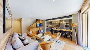 a living room with a couch and a table at Nouveau ! Chalet pied des pistes in Champagny-en-Vanoise