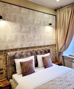a bedroom with a large bed with a large wall at Central Apartments in Odesa