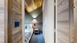 a guest room with a bed and a door to a bedroom at Nouveau ! Chalet pied des pistes in Champagny-en-Vanoise