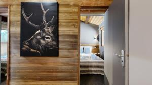 a door with a picture of a deer in a bedroom at Nouveau ! Chalet pied des pistes in Champagny-en-Vanoise