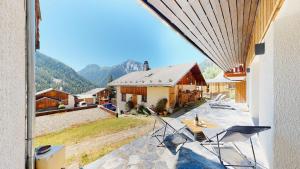 a view from a balcony of a house with mountains at Nouveau ! Chalet pied des pistes in Champagny-en-Vanoise