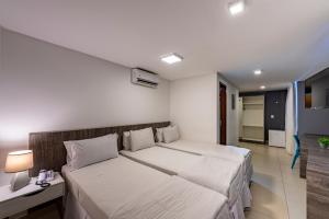 a bedroom with two beds in a room at Hotel Mais1 in Campina Grande