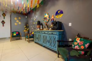 a room with a blue cabinet and a mirror at Hotel Mais1 in Campina Grande