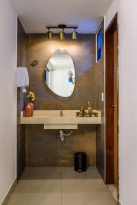 a bathroom with a sink and a mirror at Hotel Mais1 in Campina Grande