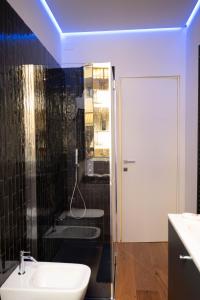 a bathroom with a white sink and a mirror at Residenza Diaz in Domodossola