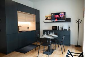 a dining room with a table and a kitchen at Residenza Diaz in Domodossola