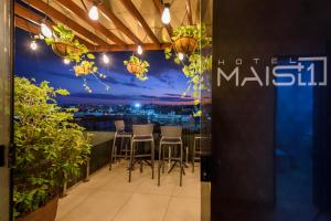 a restaurant with a table and chairs on a balcony at Hotel Mais1 in Campina Grande