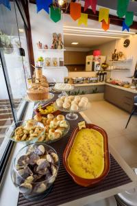 a buffet with many different types of food on a counter at Hotel Mais1 in Campina Grande