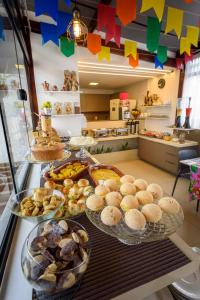 a buffet with many plates of food on a counter at Hotel Mais1 in Campina Grande