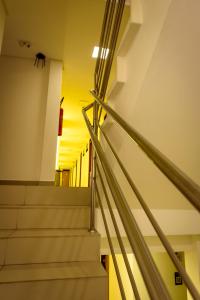 a set of stairs in a building with the sunset in the background at Hotel Mais1 in Campina Grande