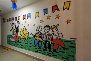 a mural of the music group on a wall in a room at Hotel Mais1 in Campina Grande