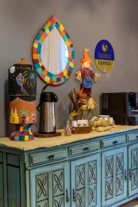 a blue cabinet with a mirror and some food on it at Hotel Mais1 in Campina Grande