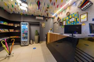 a store interior with a counter and a refrigerator at Hotel Mais1 in Campina Grande