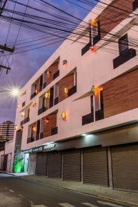a building with garages on the side of a street at Hotel Mais1 in Campina Grande
