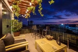 a patio with a table and chairs on a balcony at Hotel Mais1 in Campina Grande