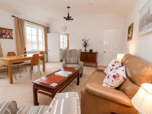 a living room with a couch and a table at 6 Granary Court in York