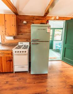 cocina con nevera antigua y fogones en Big Blue Lake Cottages, LLC - Cottage #2, en Holton