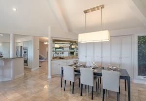 a kitchen and dining room with a table and chairs at 3906 Ocean's One Eleven home in Carmel