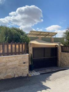 a house with a wooden fence and a garage at Simple home in Madaba