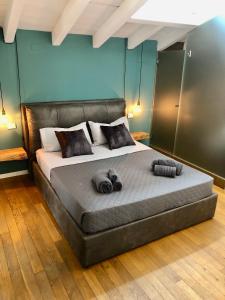 a bedroom with a bed with two towels on it at Luxury industrial apt vicino al centro con garage in Brescia