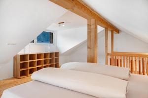 a attic bedroom with two beds and a staircase at Apartement Bens Auszeit Top 5 in Umhausen