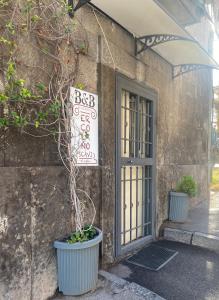 a building with a plant in a pot next to a door at b&b ERCOLANO Scavi in Ercolano