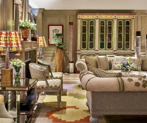 a living room with couches and chairs and a fireplace at The Soho Hotel, Firmdale Hotels in London