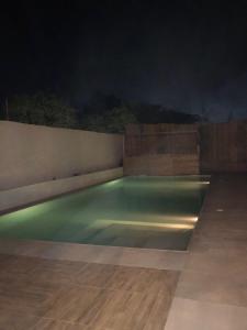 a swimming pool at night on a patio at NDARI in Siendou