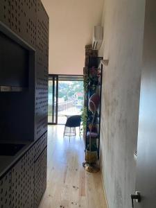 a living room with a television and a wooden floor at Casas de Pousadouro in Baião