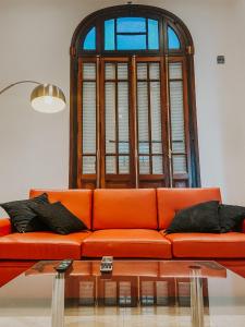 un sofá naranja en una sala de estar con ventana en Categórica Casa con Cocina Premium 3 Habitaciones en Centro de Paraná en Paraná