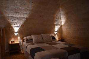 een slaapkamer met een bed in een bakstenen muur bij Faliero Room in Canosa di Puglia