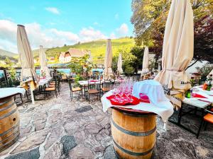 a restaurant with tables and chairs and umbrellas at Weinhotel Wachau in Spitz