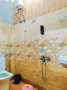 a shower in a bathroom with a toilet at Metroview rooms & hotel in Bahādurgarh