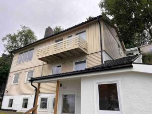 a house with a balcony on top of it at Penthouse with panorama view and great location! in Tromsø