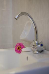 a sink with a faucet with a pink flower on it at Georgias House in Skiros