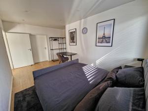 a bedroom with a bed and a table in it at Moderne Wohnung in Bad Berleburg in Bad Berleburg