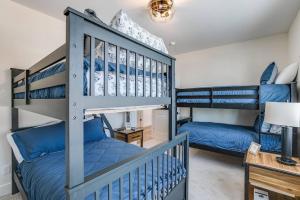 a bedroom with two bunk beds and a desk at Luxury Estate with Stadium TDJ Views Sleeps 20 in South Bend