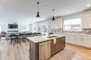 a large kitchen with white cabinets and a kitchen island at Luxury Estate with Stadium TDJ Views Sleeps 20 in South Bend